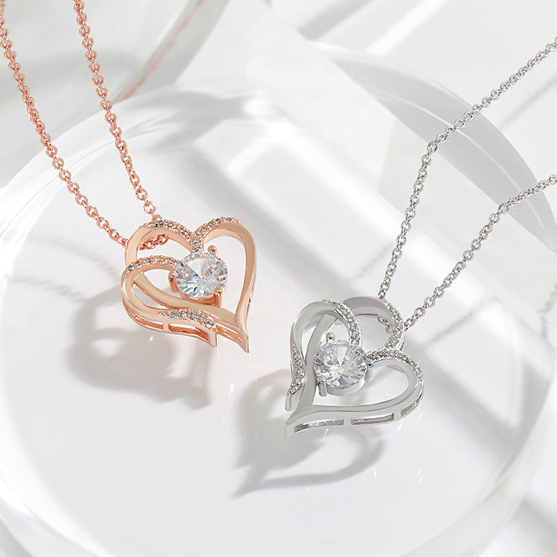 Elena | Necklace with a charming double heart and sparkling zircons.