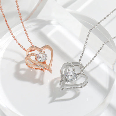 Elena | Necklace with a charming double heart and sparkling zircons.