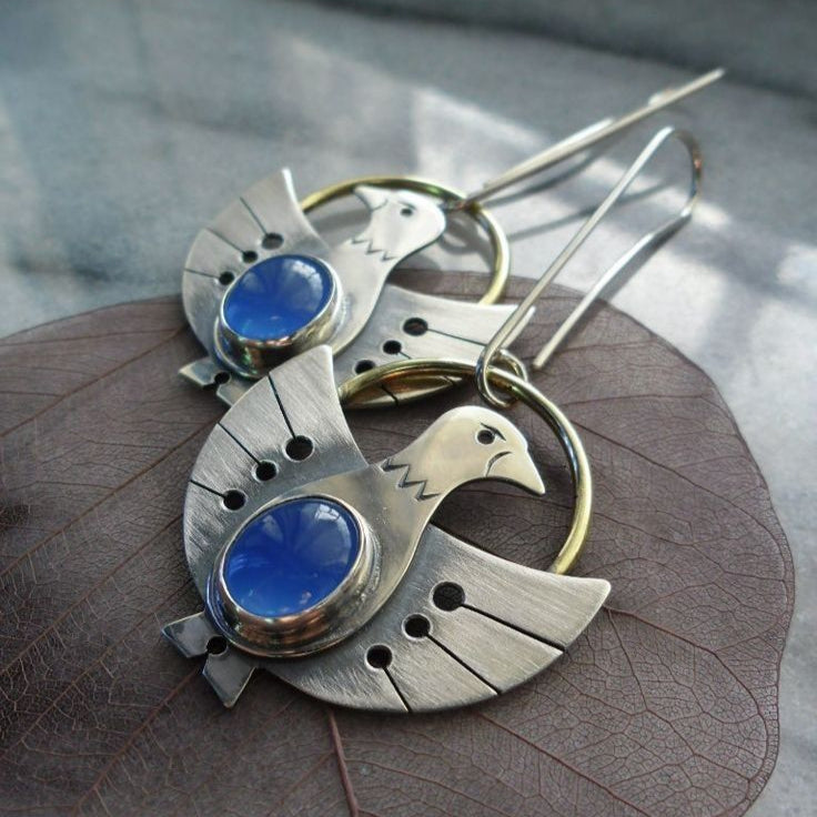 Inés | Silver bird earrings with sparkling blue crystal