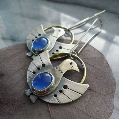 Inés | Silver bird earrings with sparkling blue crystal