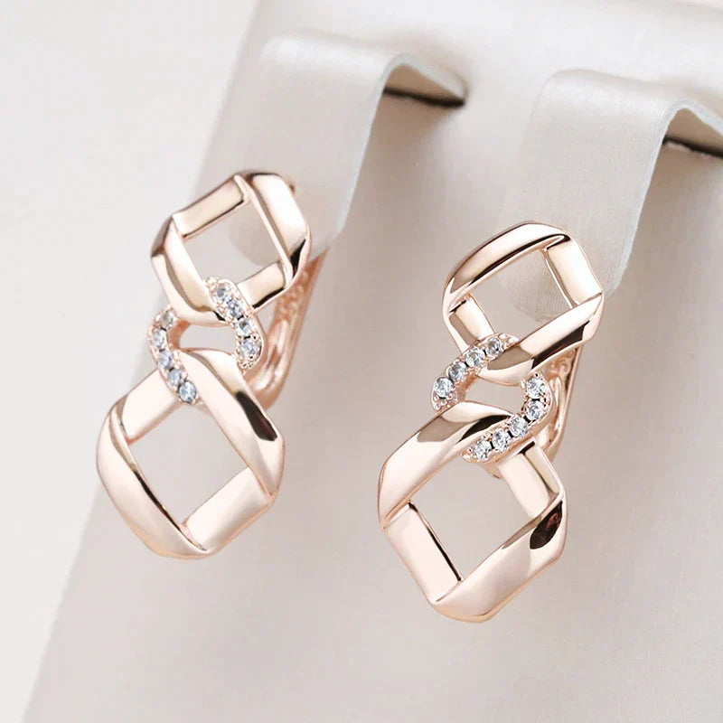Eugenia | Stylish golden earrings with zirconia and an elegant knot design