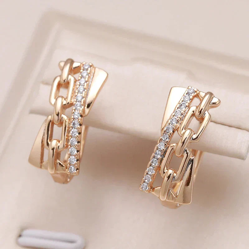 esenia | Elegant gold earrings with shiny chain details