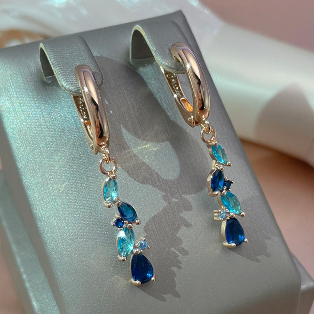 Holland | Glamorous radiant blue crystal earrings in shiny gold