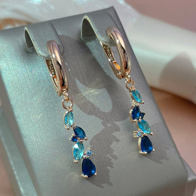 Holland | Glamorous radiant blue crystal earrings in shiny gold