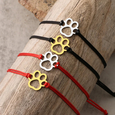 Emma | ELINE – Elegant adjustable paw-shaped bracelet with black and red cord.