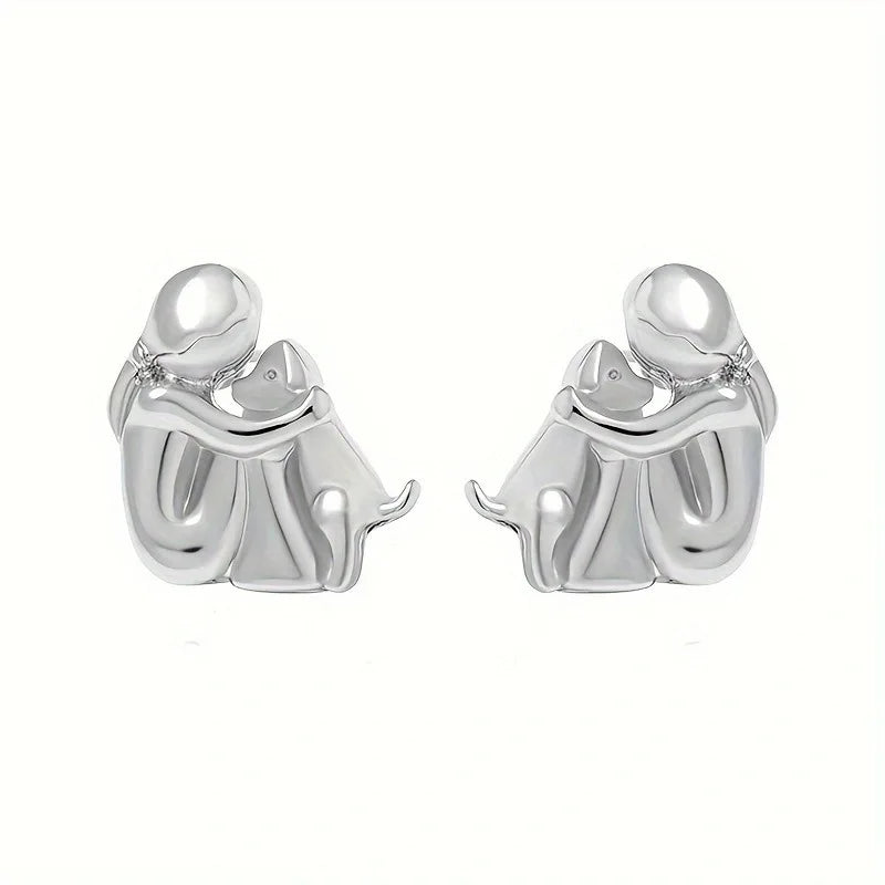 Paola | Hug earrings in silver and gold.