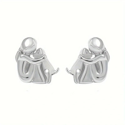 Paola | Hug earrings in silver and gold.
