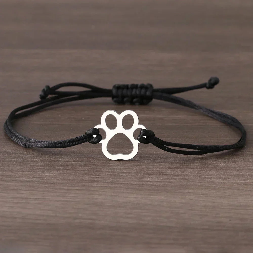 Emma | ELINE – Elegant adjustable paw-shaped bracelet with black and red cord.