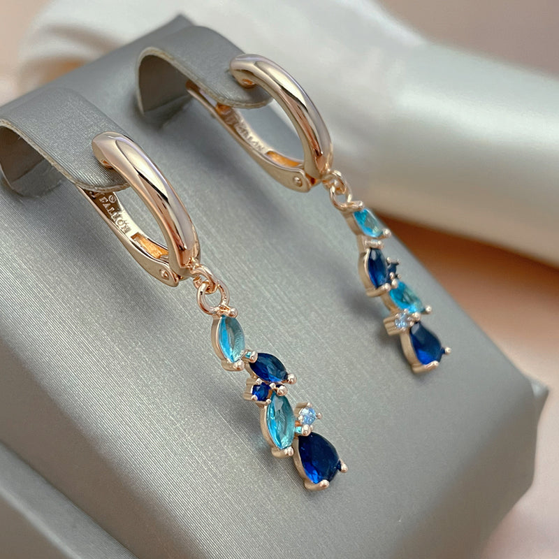 Holland | Glamorous radiant blue crystal earrings in shiny gold