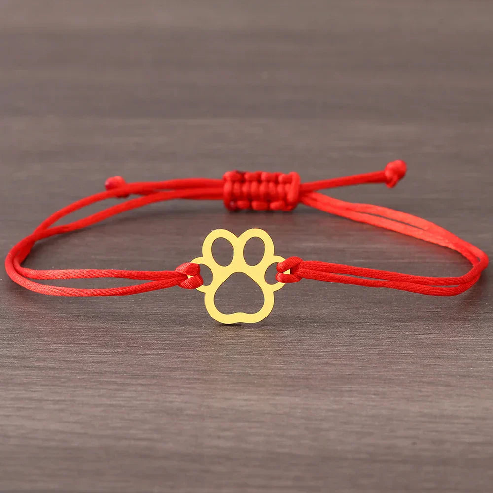 Emma | ELINE – Elegant adjustable paw-shaped bracelet with black and red cord.