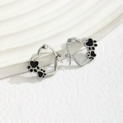 Olga | Silver-effect paw heart hoop earrings with black enamel.