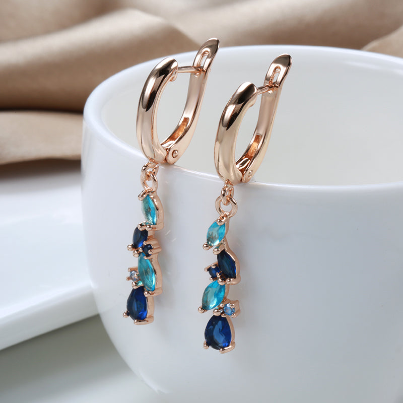 Holland | Glamorous radiant blue crystal earrings in shiny gold