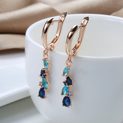 Holland | Glamorous radiant blue crystal earrings in shiny gold