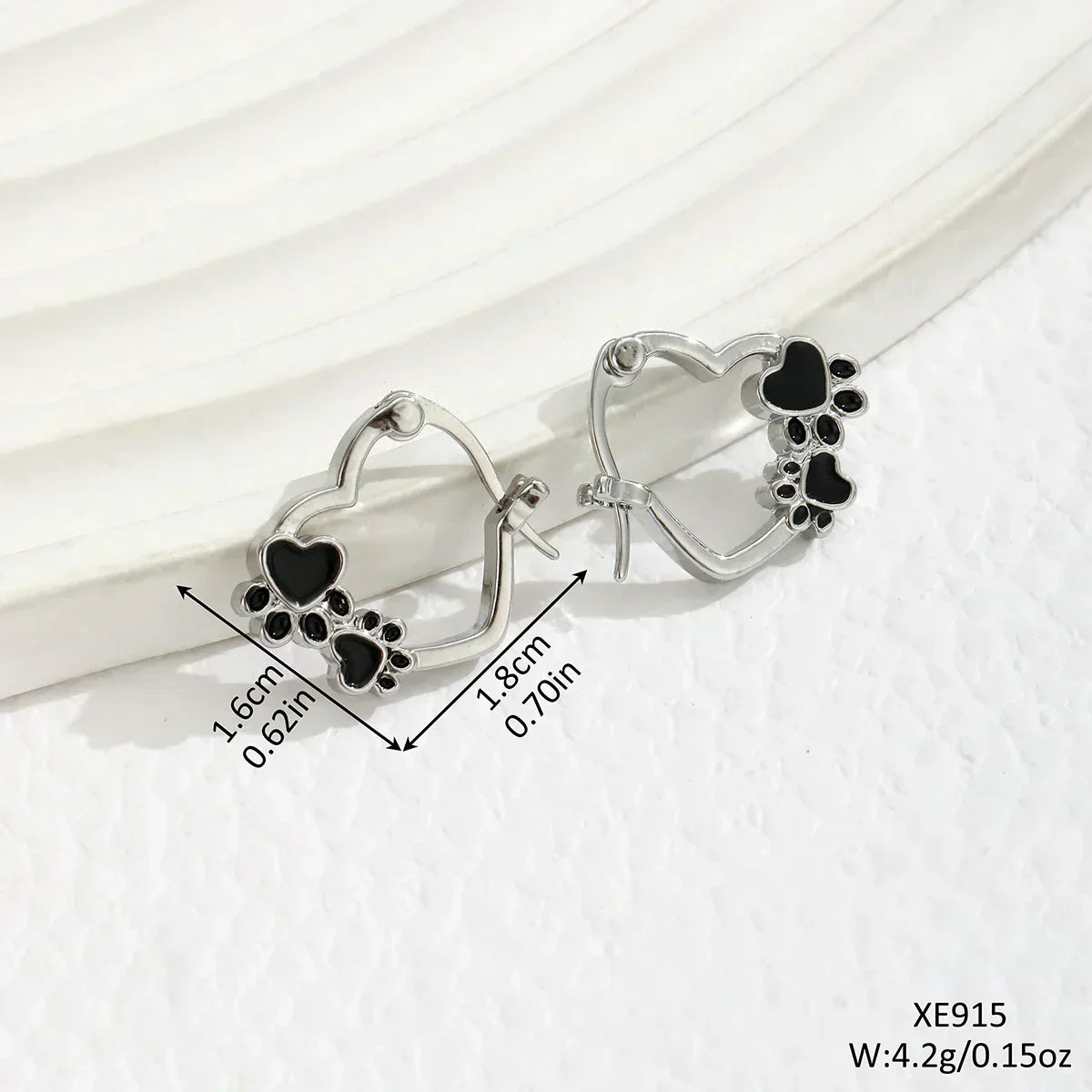 Olga | Silver-effect paw heart hoop earrings with black enamel.