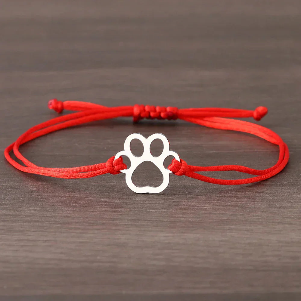 Emma | ELINE – Elegant adjustable paw-shaped bracelet with black and red cord.