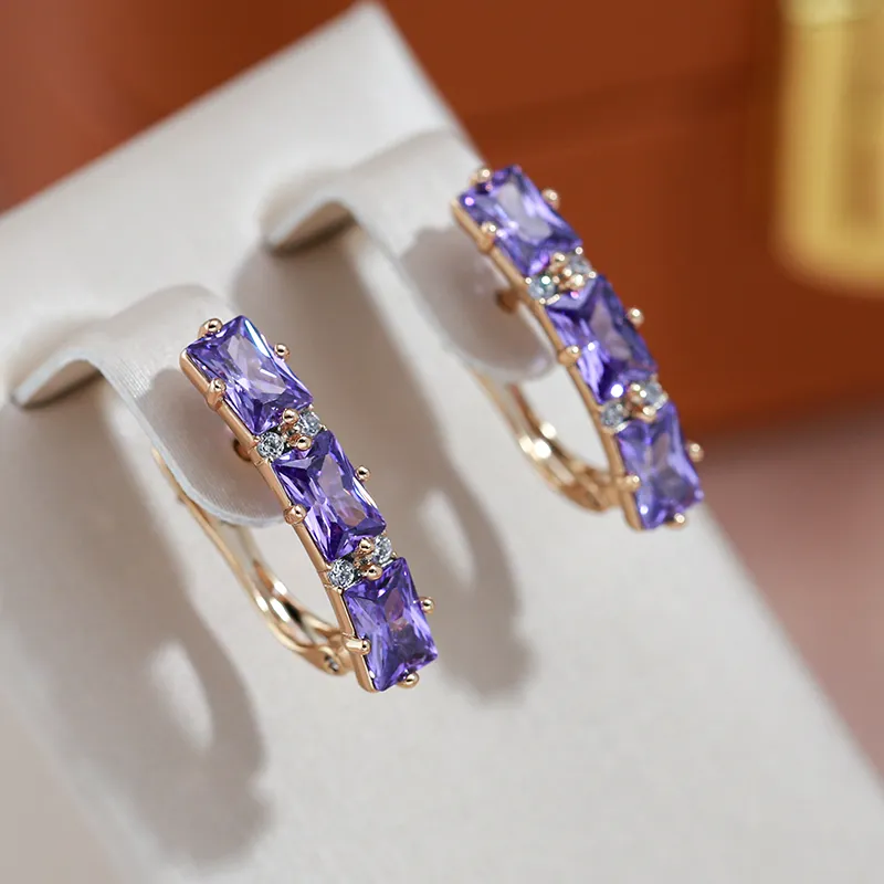 Valeria | Glamorous gold earrings with radiant purple crystals